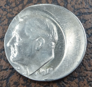 1972 Roosevelt dime off-center strike error showing design shifted from center with crescent blank area